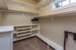 Walk-in closet in master with great storage, hangers, extra blankets